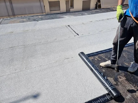 Crew installing a PVC flat roof in Long Island, NY